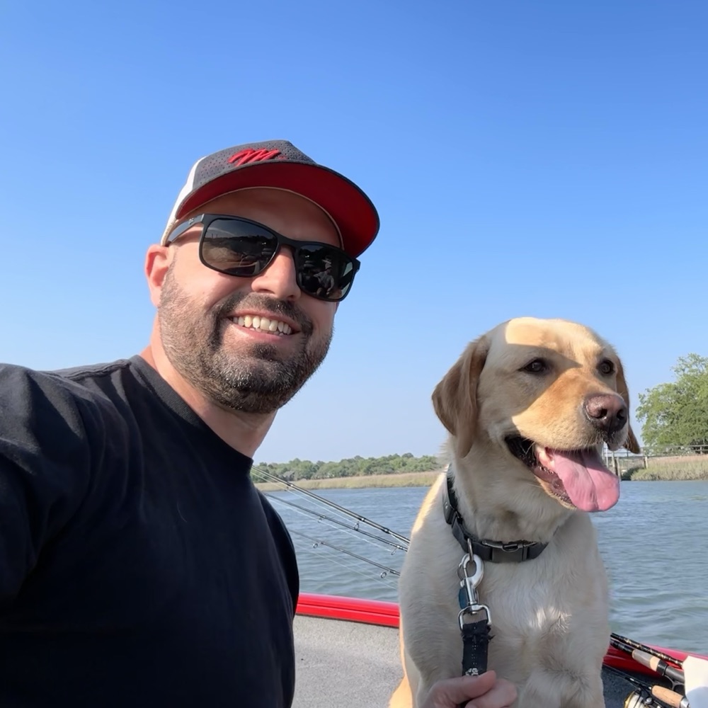 Chris Mailhoit, founder of Modern Upline, out on the water with his dog Maddie